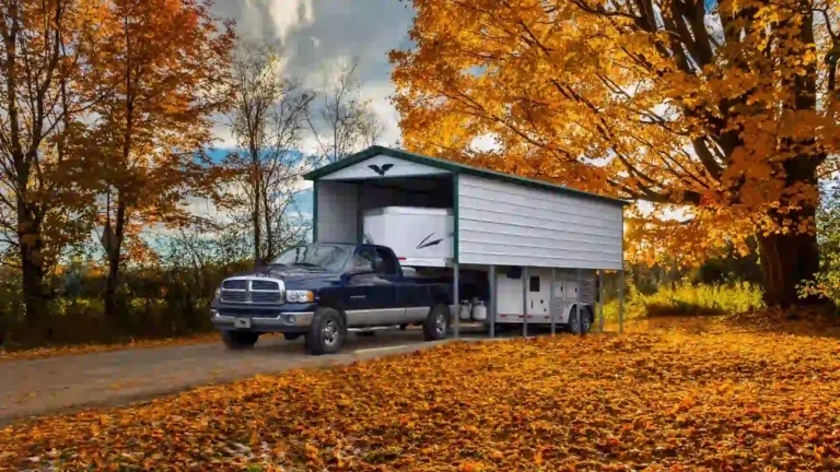 12x30x12 vertical roof metal carport sheltering truck and RV in autumn landscape. This durable metal carport is one of our metal carports for sale from Eagle Carports, offering all-season vehicle protection.