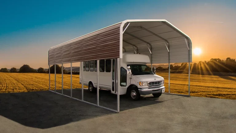 18x30x9 regular roof metal carport covering a large white shuttle bus at sunset. This durable metal carport provides spacious protection, and Eagle Carports offers metal carports for sale to keep vehicles safe from the elements.
