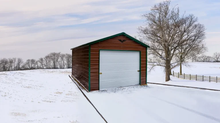 14x25x9 vertical roof metal garage with a wood-look finish and roll-up door in a snowy landscape. This durable metal garage provides secure storage for vehicles and equipment, and Eagle Carports has metal garages for sale to protect your valuables year-round.