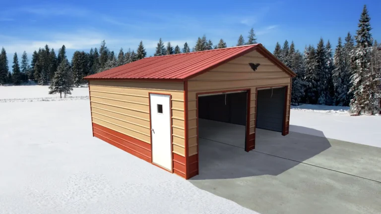 16x20x8 vertical roof metal garage with red trim, two roll-up doors, and side entry door in a snowy landscape. This durable metal garage provides secure storage for vehicles and equipment, and Eagle Carports offers metal garages for sale to protect valuables year-round.