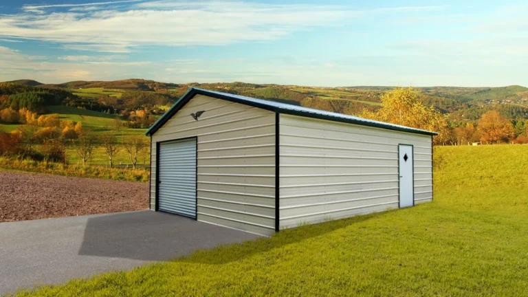 16x25x8 vertical roof metal garage with roll-up door and side entry door on a grassy lot surrounded by hills. This spacious metal garage provides secure storage for vehicles and equipment, and Eagle Carports offers metal garages for sale to protect your valuables in any weather.